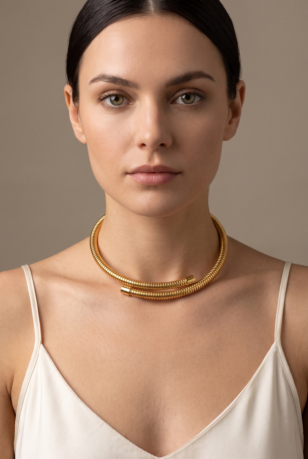 Ribbed snake-tube torque choker in gold worn on the neck